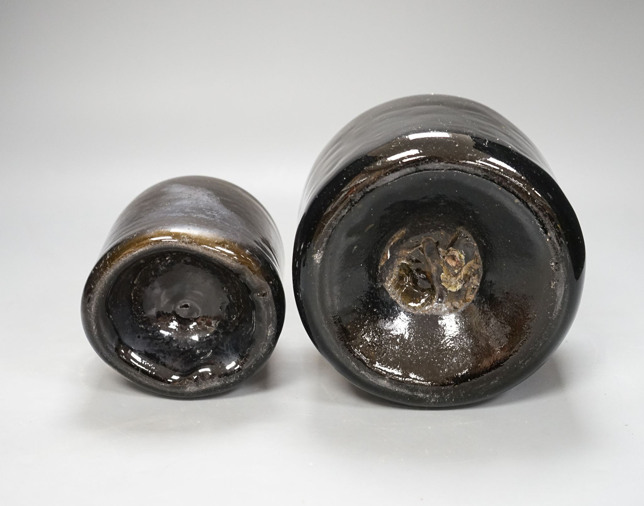 Two mid 18th century glass mallet-shape wine bottles, tallest 27cm